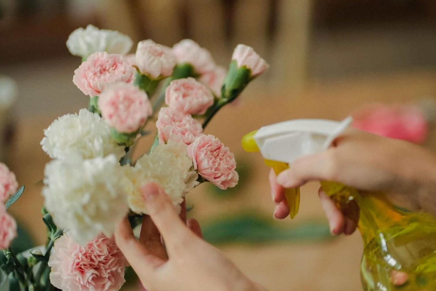 Florist arranging seasonal stems in a workshop setting
